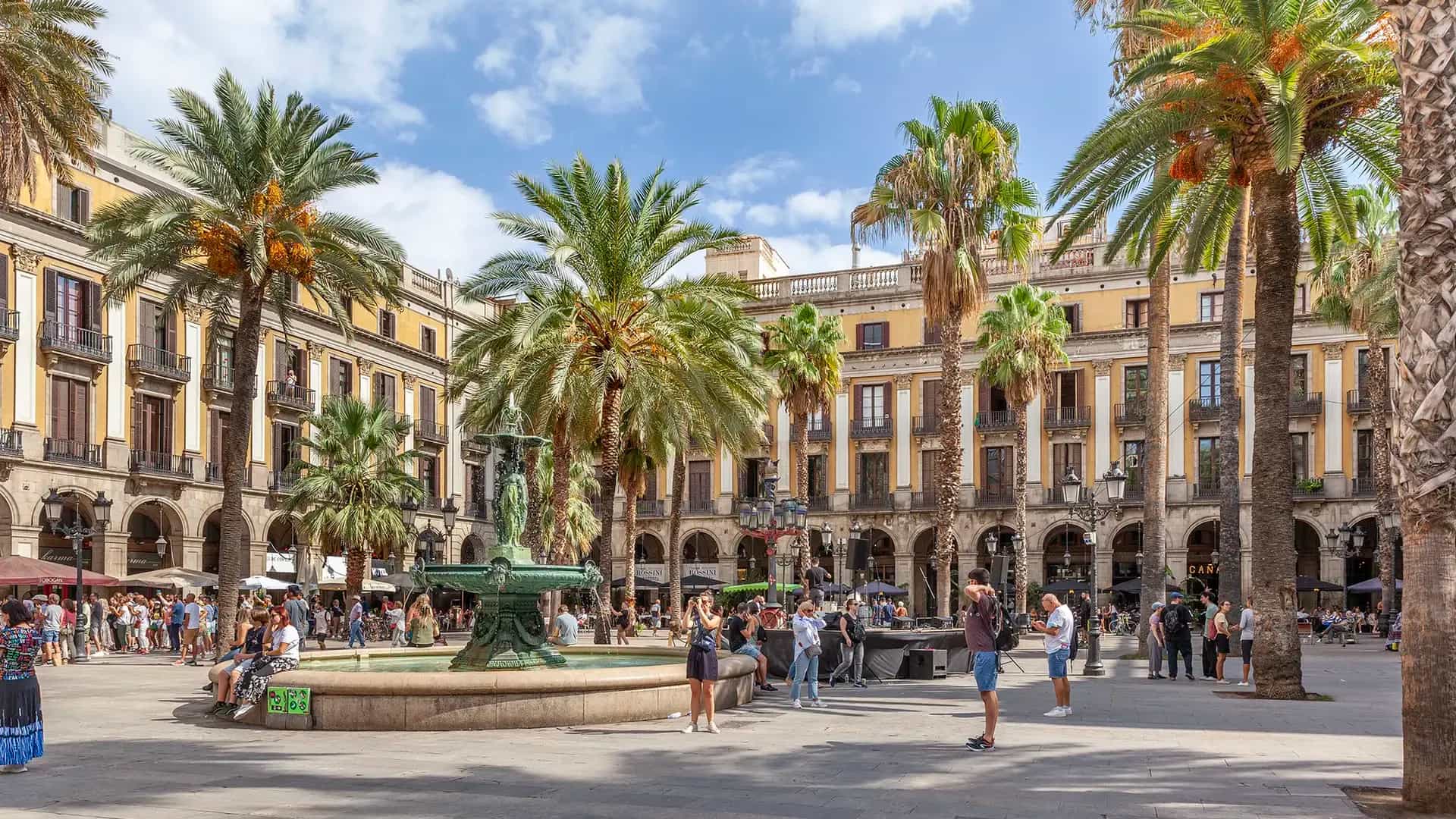 Plaza con palmeras, farolas y edificios porticados